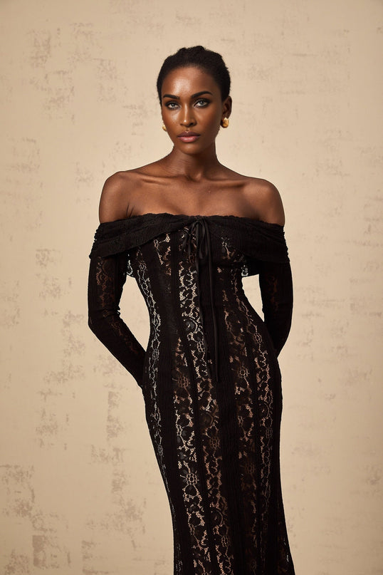 A black midi dress with floral lace pattern and flared cuffs named Emeline