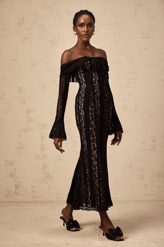 A black midi dress with floral lace pattern and flared cuffs named Émeline
