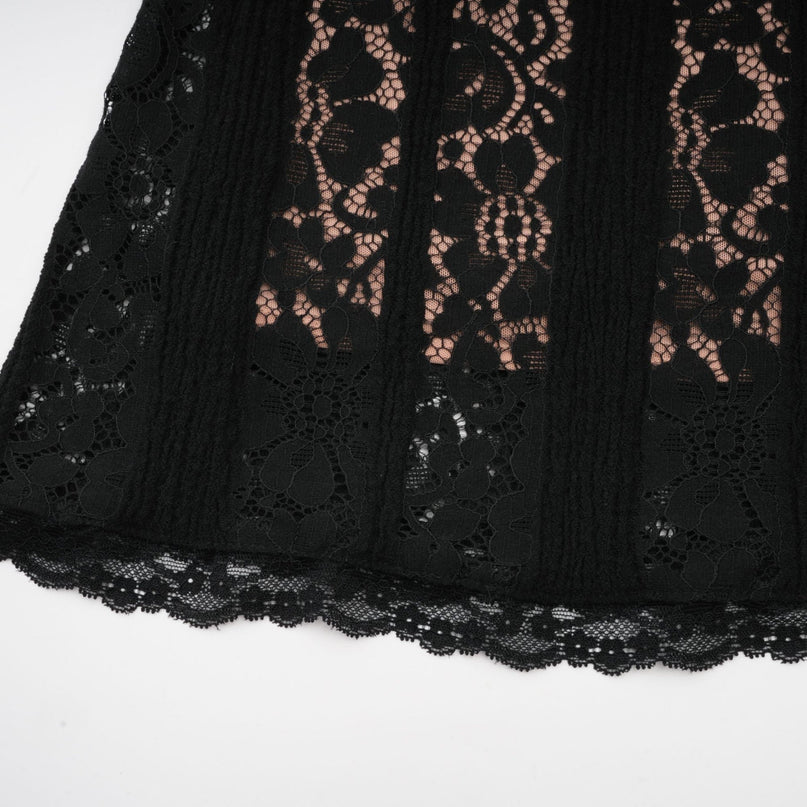 A black midi dress with floral lace pattern and flared cuffs named Émeline