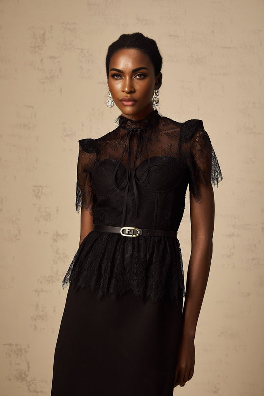 A black midi dress with guipure lace panels and no belt featuring a design inspired by Therese