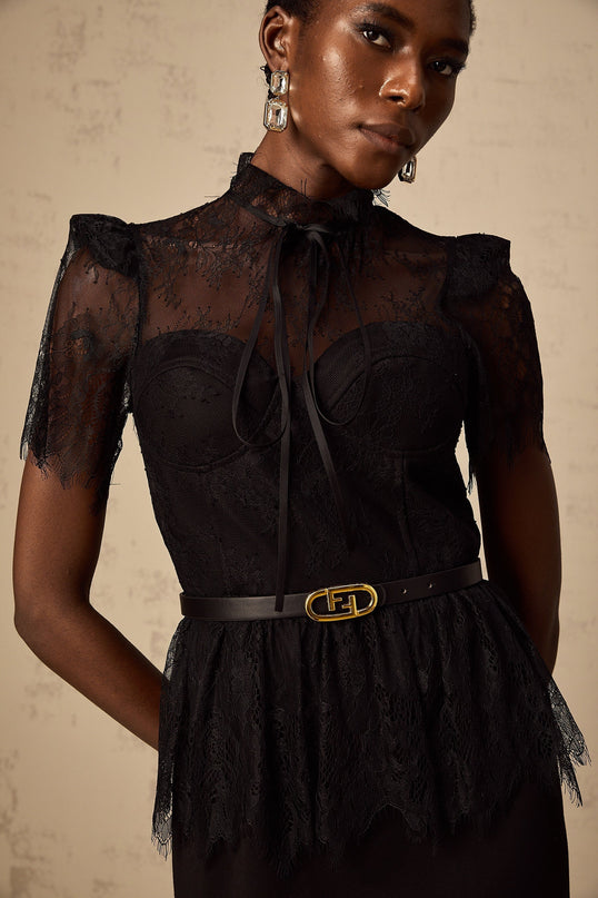 A black midi dress with guipure lace panels featuring a fitted silhouette and no belt Thérèse style