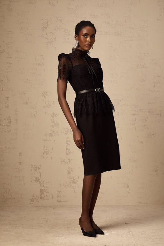 A black midi dress with guipure lace panels featuring a fitted silhouette and sleeveless design shown without a belt
