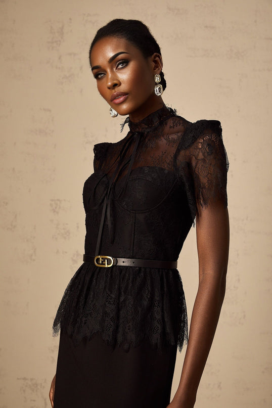 A black midi dress with guipure lace panels featuring a fitted silhouette and sleeveless design without a belt