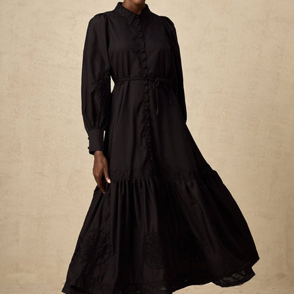 A black midi dress with lace embroidery details and a fitted silhouette