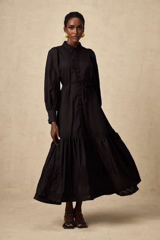A black midi dress with lace embroidery details and a fitted silhouette