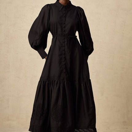 A black midi dress with lace embroidery details and a fitted silhouette