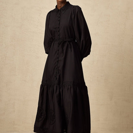 A black midi dress with lace embroidery details in an Arcadia style