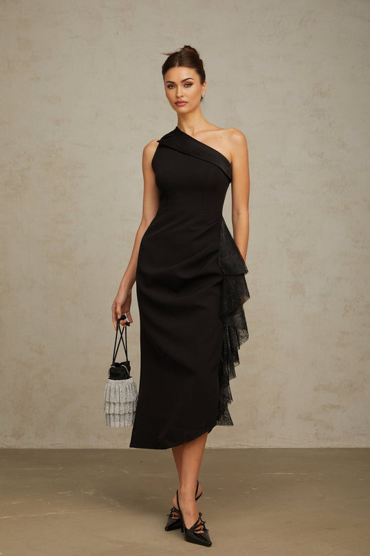 A black midi dress with lace panels and an asymmetric hemline featuring a fitted silhouette and elegant design