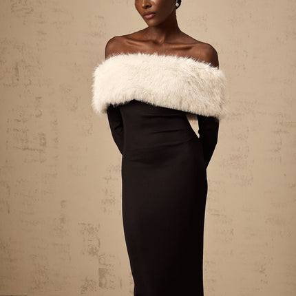 A black midi dress with offshoulder design and faux fur trim worn by a model against a plain background