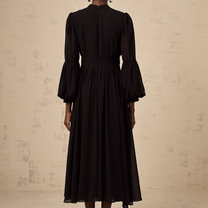 A black midi dress with pleated details and a buttonfront design called Viviane