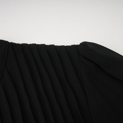 A black midi dress with pleated details and a buttonfront design featuring long sleeves and a fitted silhouette