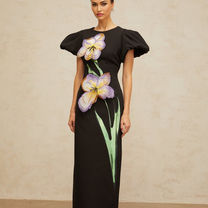 A black midi dress with sequin embellishments and floral embroidery featuring long sleeves and a fitted silhouette