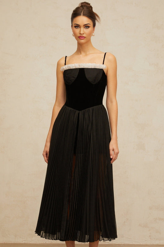 A black midi dress with velvet panels and pleated detailing named Clemence