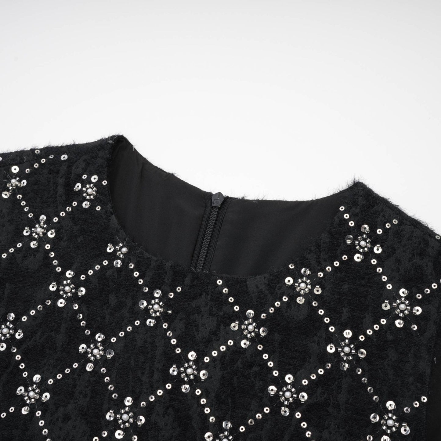 Black sleeveless dress with round neckline rear zipper and sparkling crystal embellishments made of premium polyester