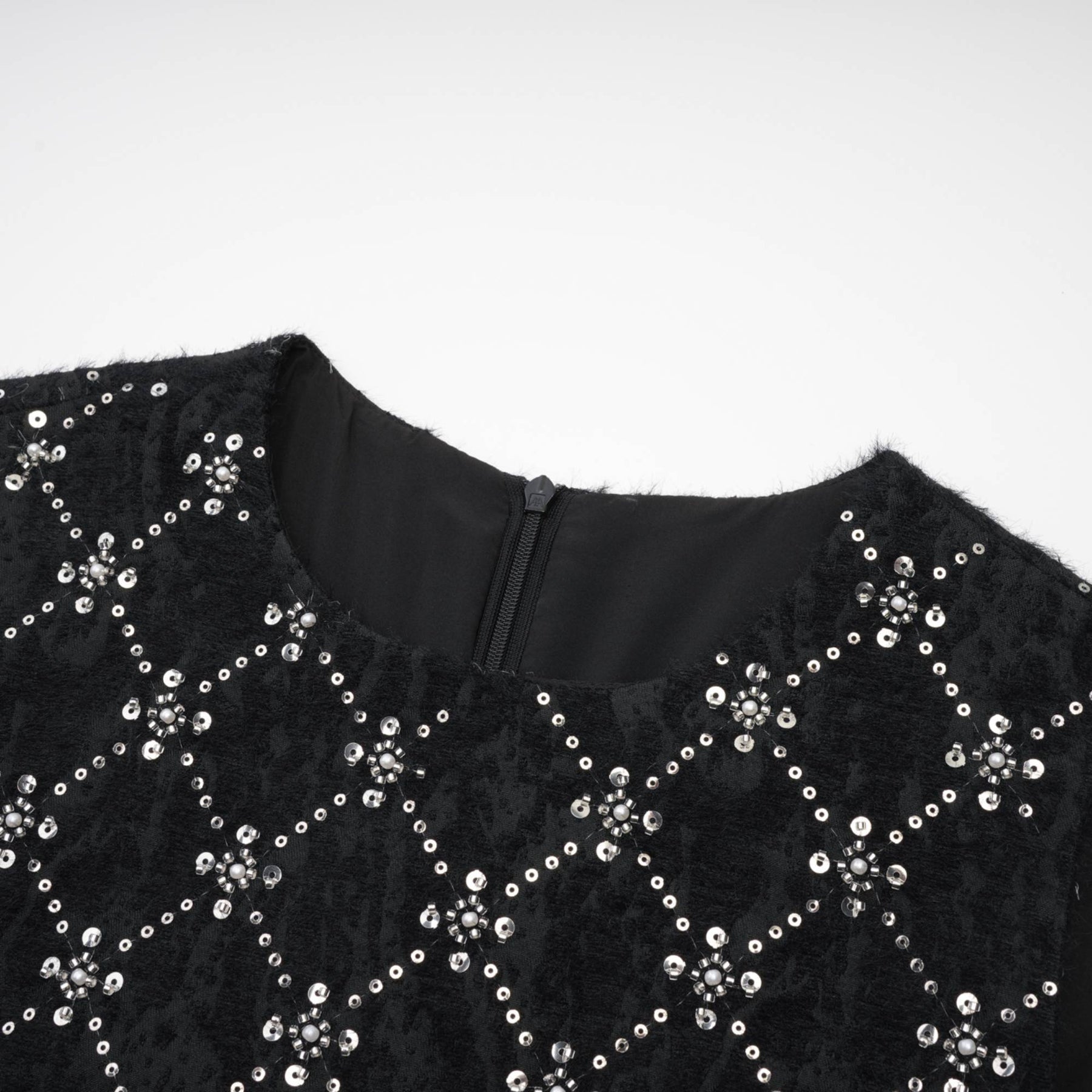 Black sleeveless dress with round neckline rear zipper and sparkling crystal embellishments made of premium polyester