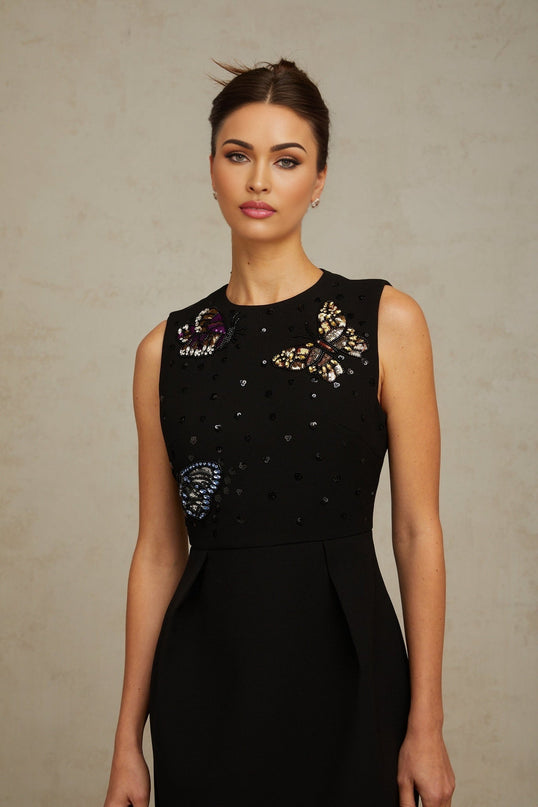 A black mini dress adorned with sequins featuring a butterfly design and a short hemline