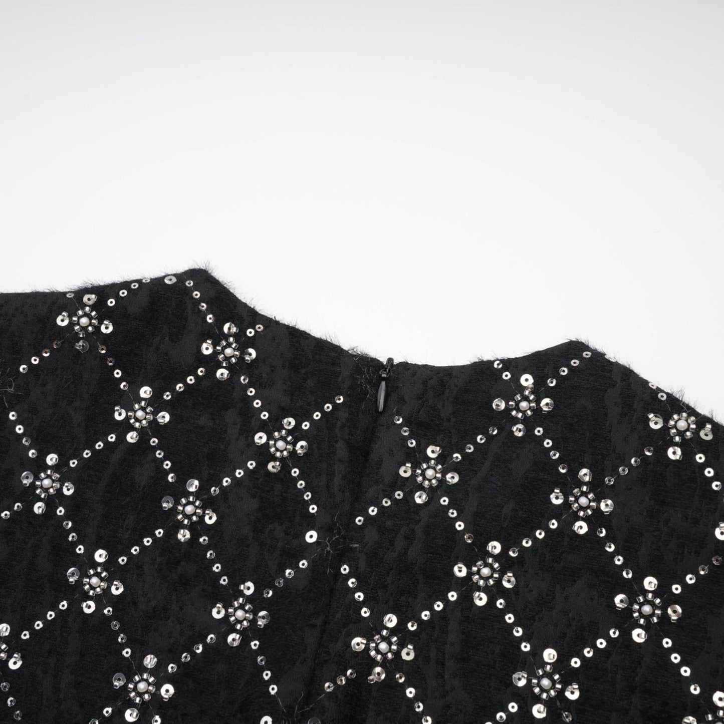 Black sleeveless dress with shiny crystal embellishments round neckline and hidden rear zipper %100 polyester composition