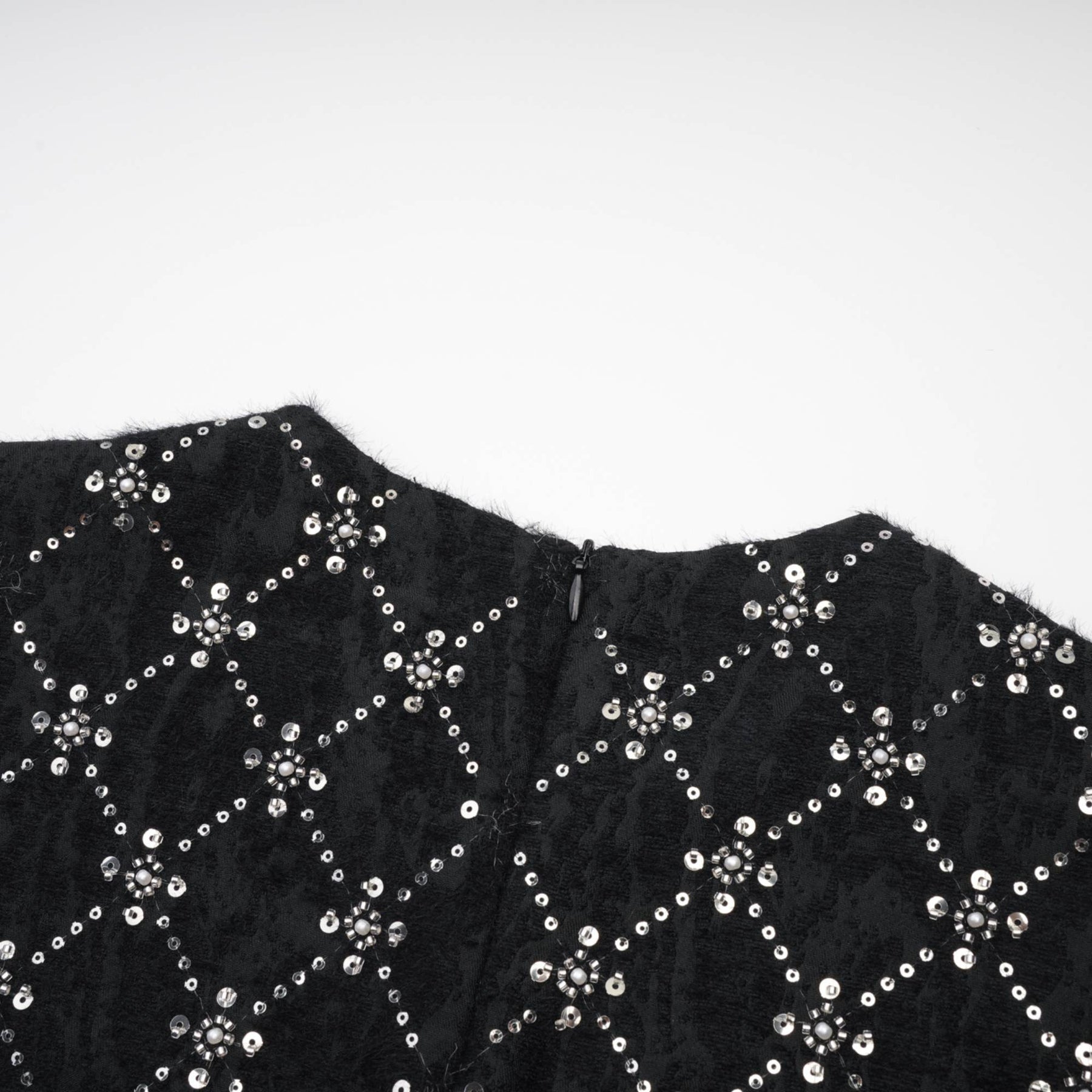 Black sleeveless dress with shiny crystal embellishments round neckline and hidden rear zipper %100 polyester composition