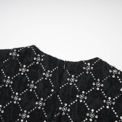 Black sleeveless dress with shiny crystal embellishments round neckline and hidden rear zipper %100 polyester composition
