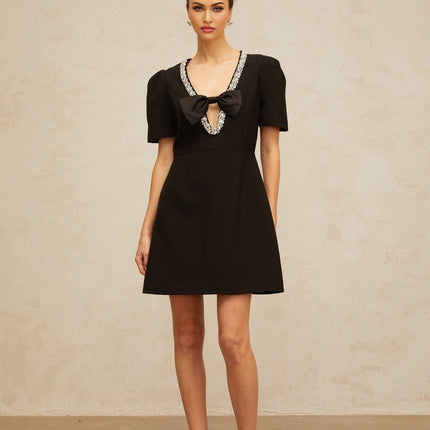 A black mini dress with a bow embellishment named Lea