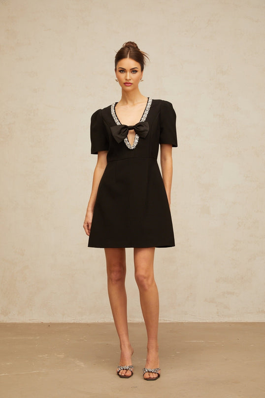 A black mini dress with a bow embellishment named Lea