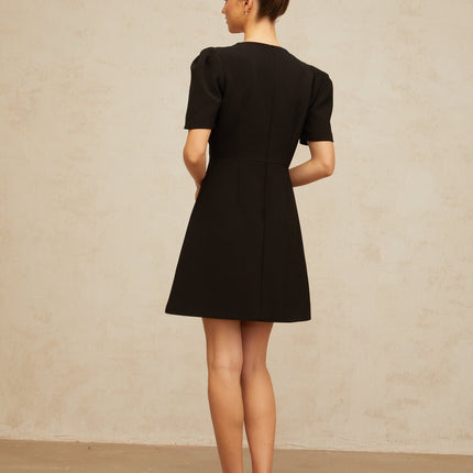 A black mini dress with a bow embellishment named Lea