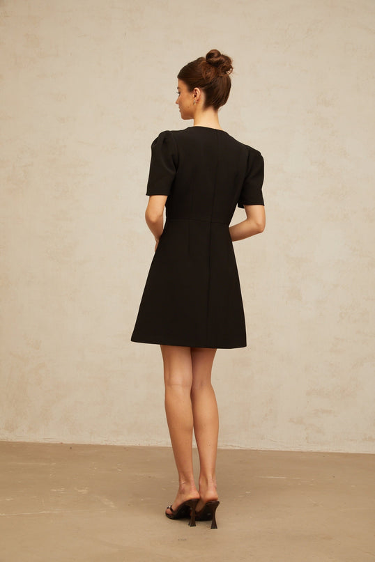 A black mini dress with a bow embellishment named Lea