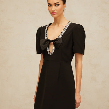 A black mini dress with a bow embellishment named Lea