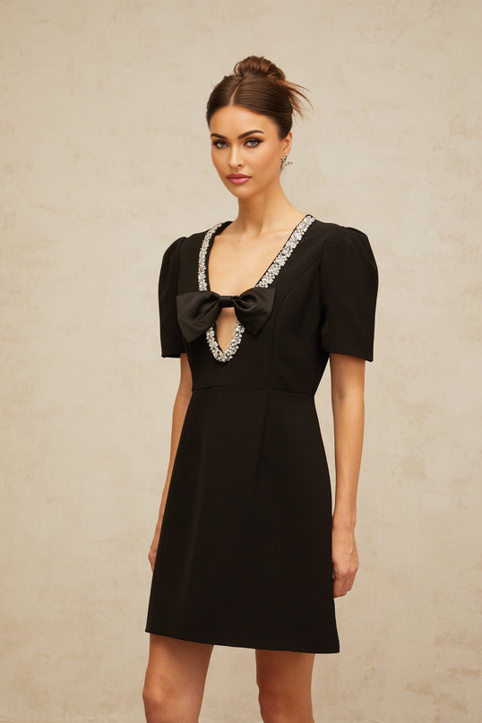 A black mini dress with a bow embellishment named Lea