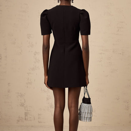 A black mini dress with a bowknot embellishment featuring a short hemline and fitted silhouette named Tania