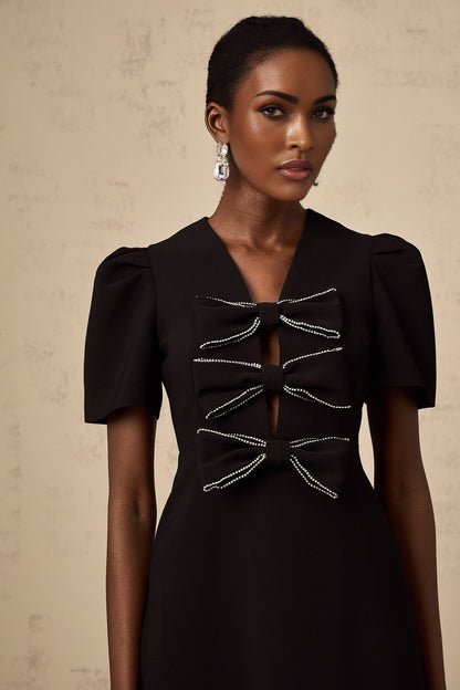 A black mini dress with a bowknot embellishment named Tania
