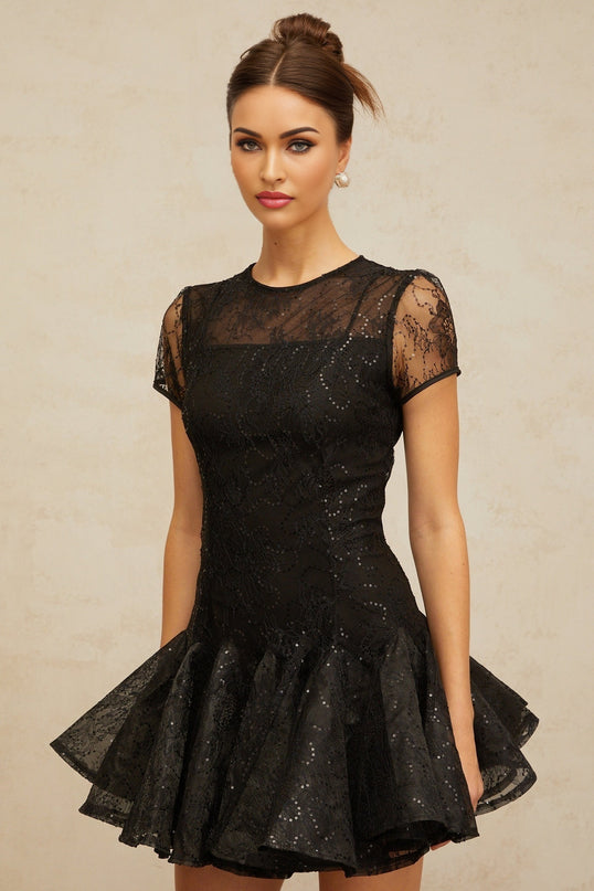 A black mini dress with a flared skirt covered in shimmering sequins