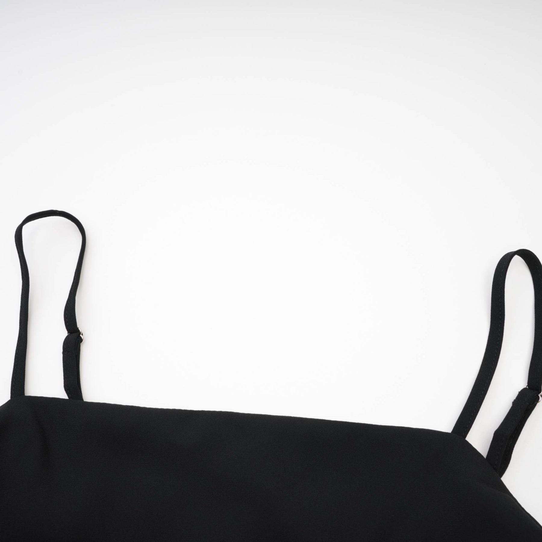 Black dress with spaghetti straps square neck floral cut zip fastening flower decoration at the neck and asymmetric design Made of 80% Polyester and 20% Cotton