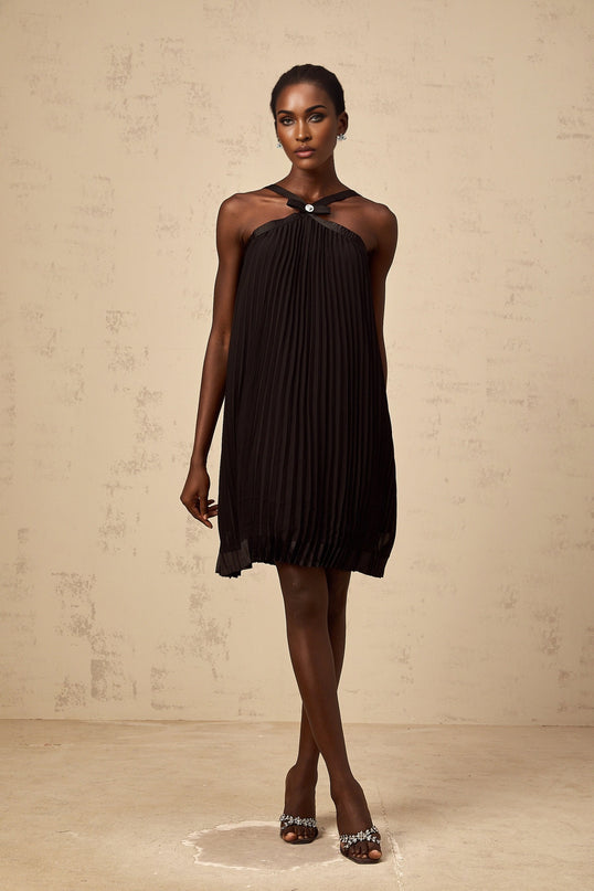 A black mini dress with a pleated skirt and a large bow accent at the waist inspired by the Zelda video game series