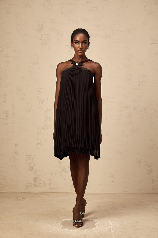 A black mini dress with a pleated skirt and a large bow detail at the waist inspired by the Zelda video game series