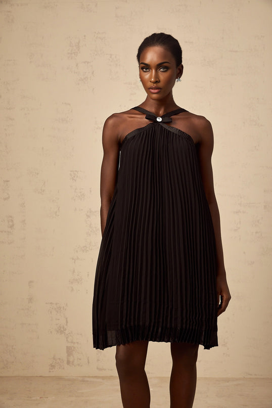 A black mini dress with a pleated skirt and a large bowknot detail inspired by the Zelda video game series