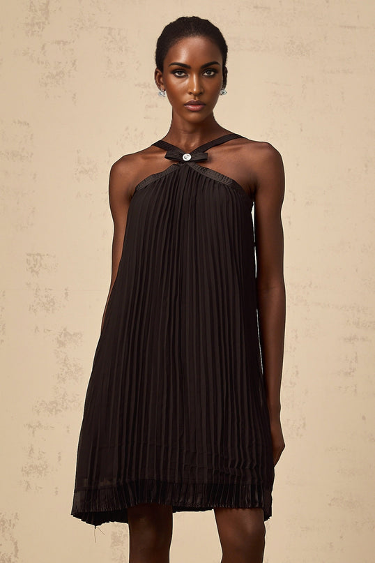 A black mini dress with a pleated skirt and a prominent bowknot detail inspired by the Zelda video game series