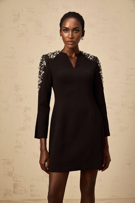 A black mini dress with a split neckline and embellished details named Beatrice