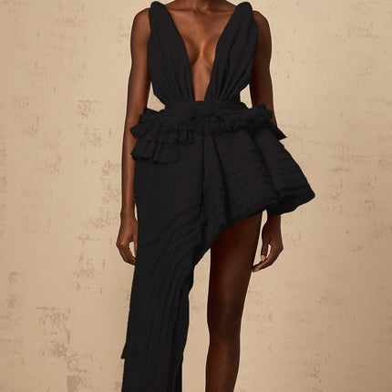 A black mini dress with an asymmetrical hemline featuring a decorative ribbon design by Isoline