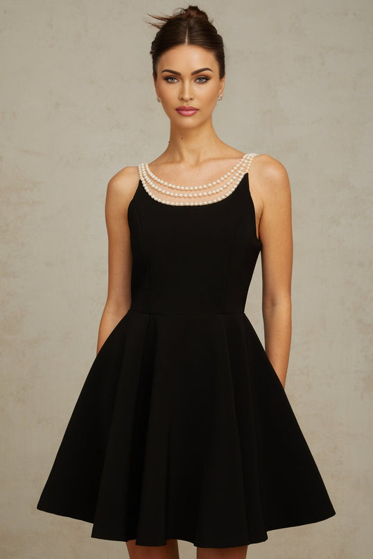 A black mini dress with faux pearl embellishments called Danae