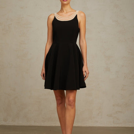 A black mini dress with faux pearl embellishments called Danae