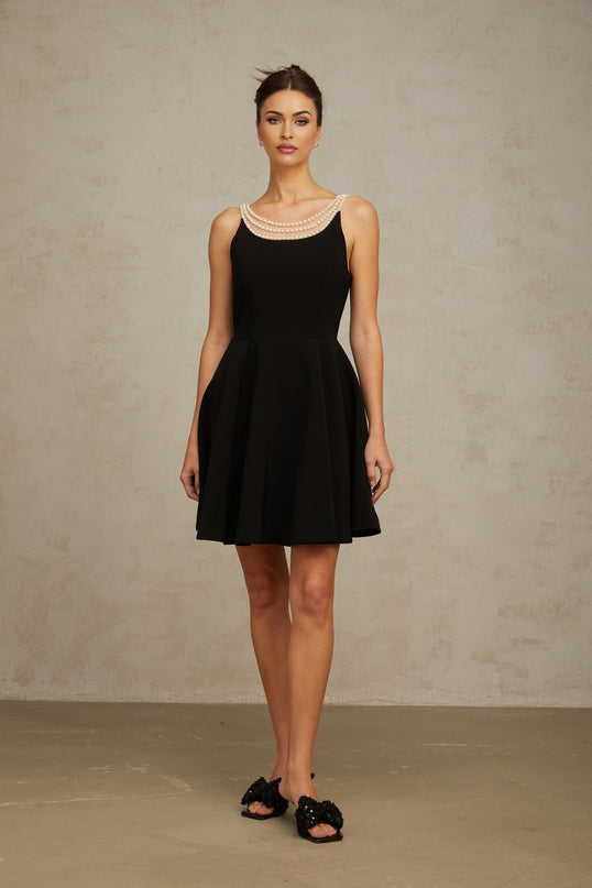 A black mini dress with faux pearl embellishments called Danae