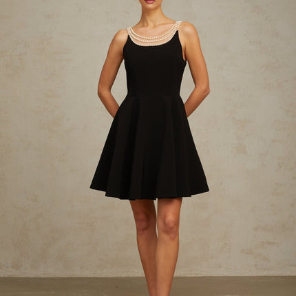 A black mini dress with faux pearl embellishments called Danae