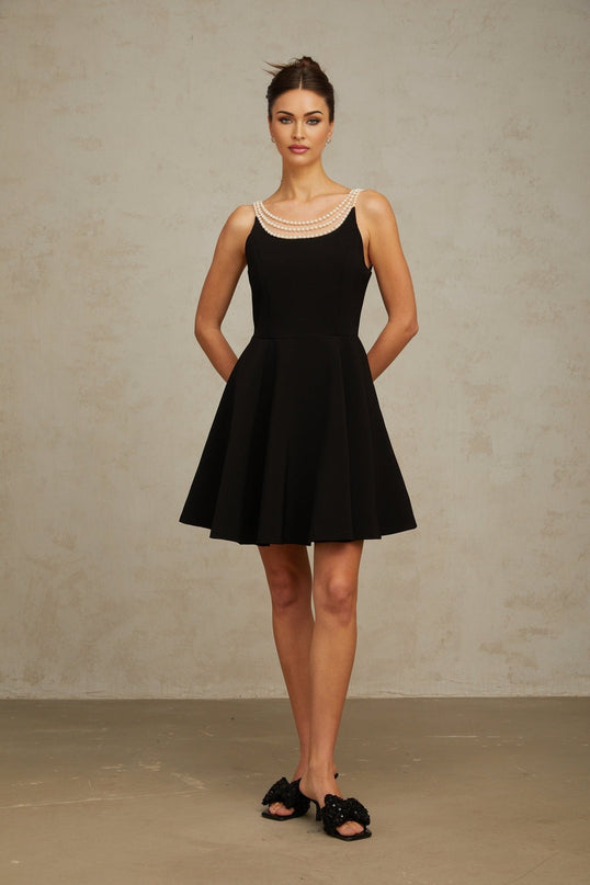 A black mini dress with faux pearl embellishments called Danae