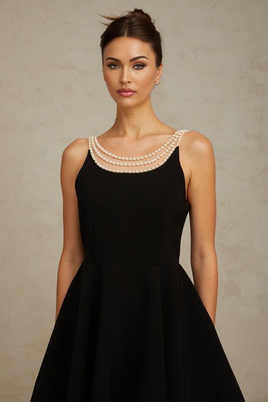 A black mini dress with faux pearl embellishments called Danae