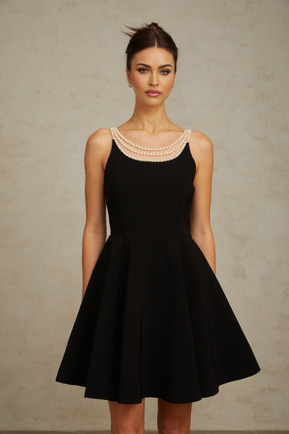 A black mini dress with faux pearl embellishments named Danae