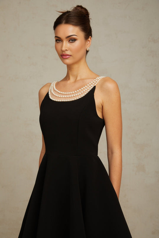 A black mini dress with faux pearl embellishments named Danae