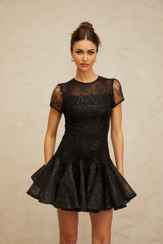 A black mini dress with flared skirt and sequin embellishments called Lara