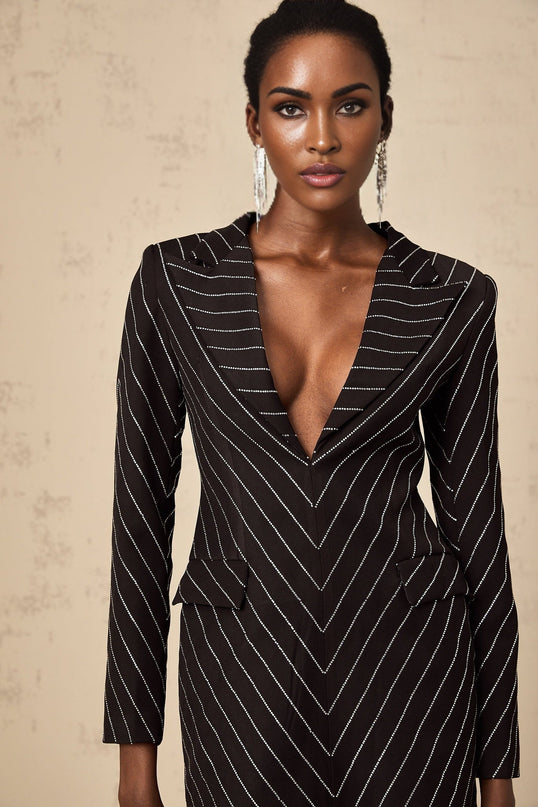 A black mini dress with horizontal stripes and embellishments named Mireille featuring a short hemline and decorative details