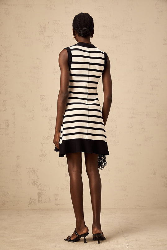 A black mini dress with horizontal stripes featuring a knit texture worn by a model standing against a plain background